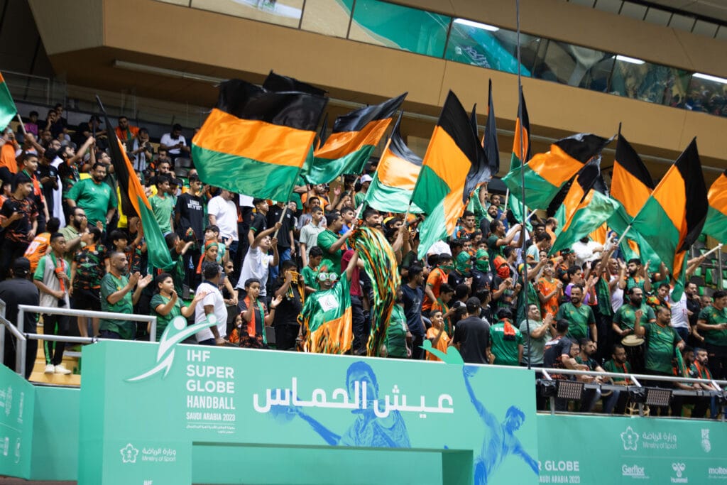 Cheering fans with flags.